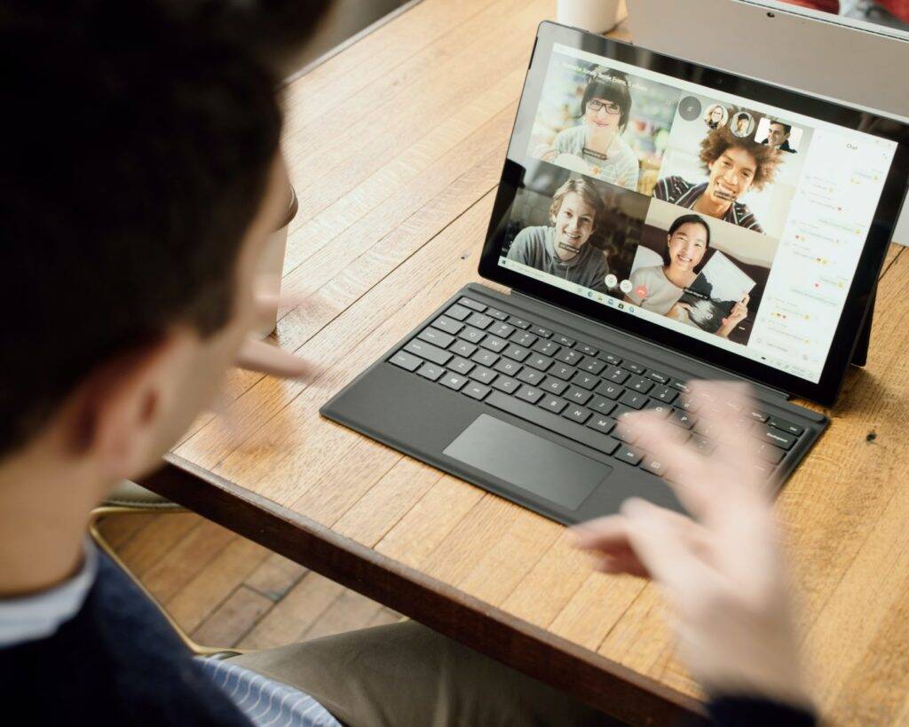 person on zoom call looking at computer