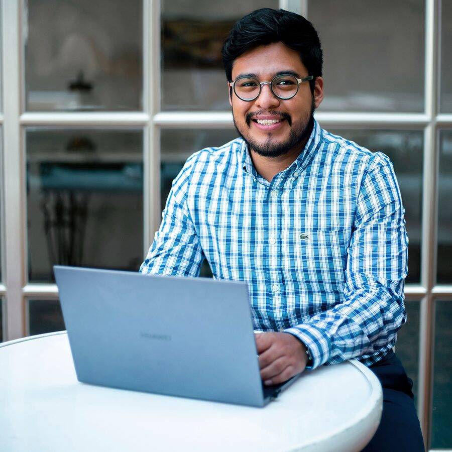 Latino man with laptop outside