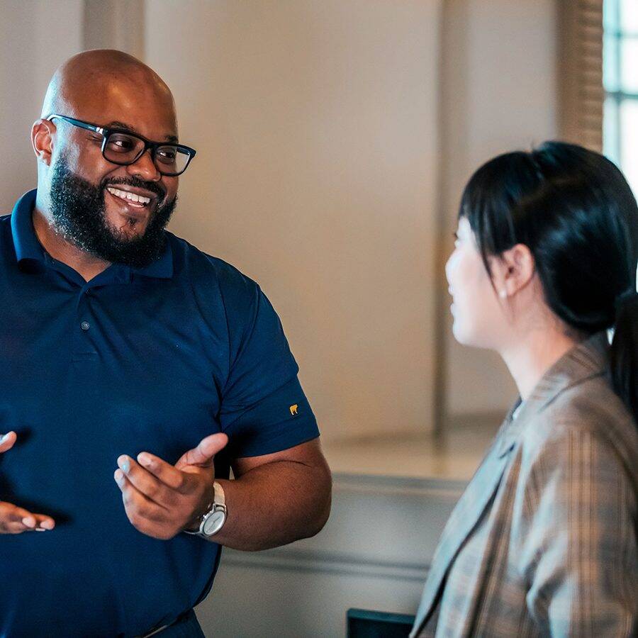 Black man talking with Asian woman