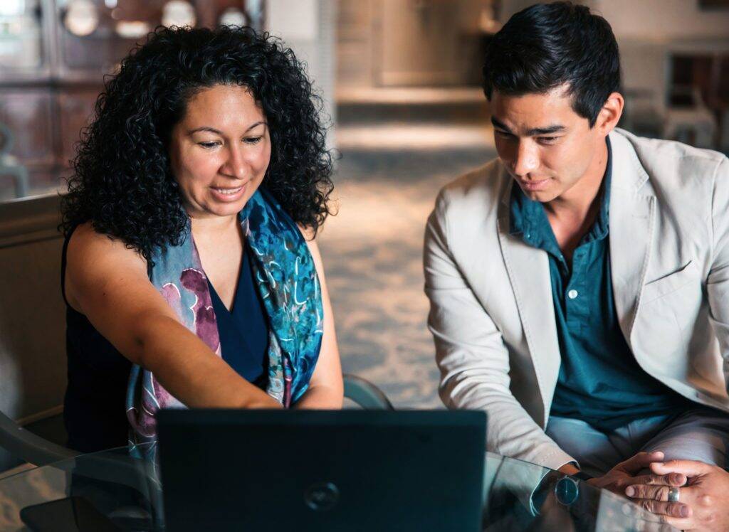 Woman and man working together with laptop