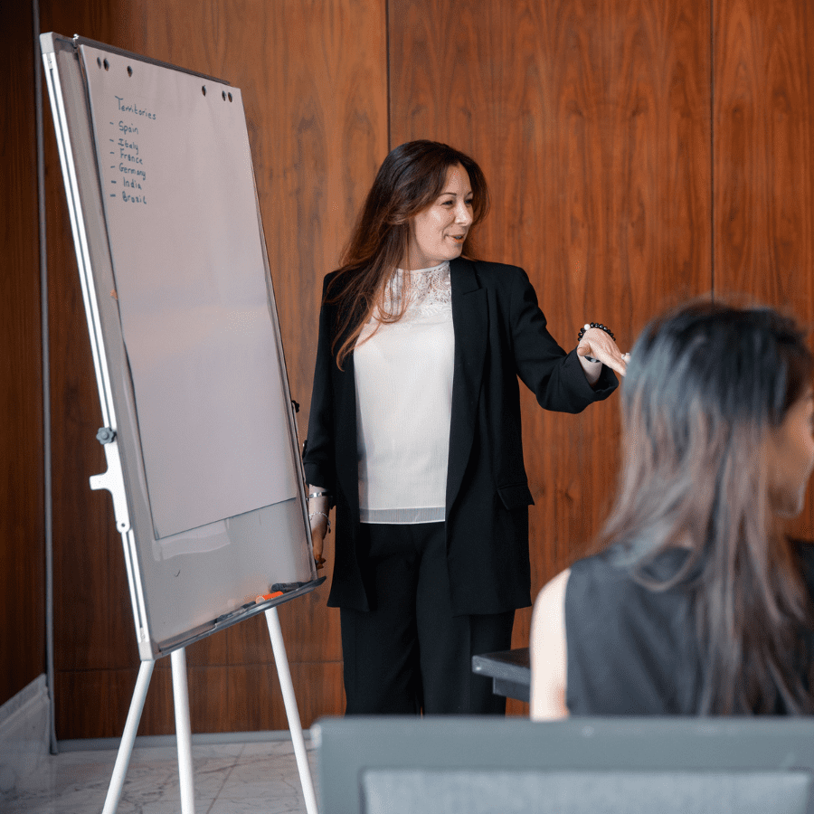 a European employee working in front of a white board