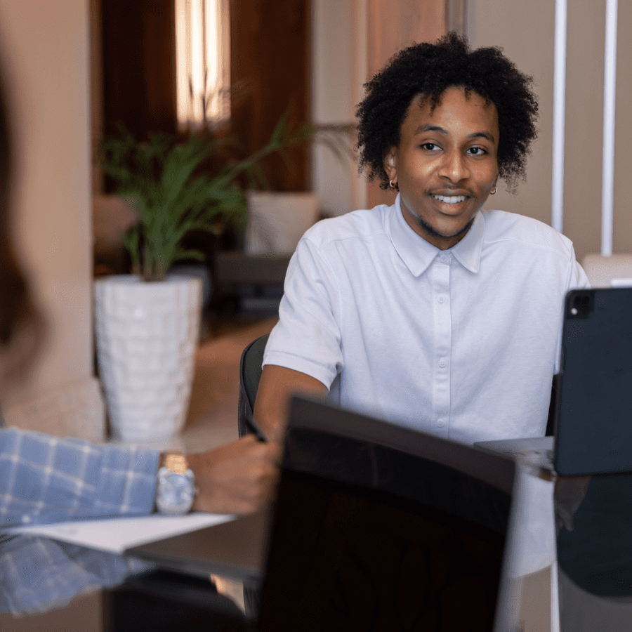 an African American employee talking to a colleague