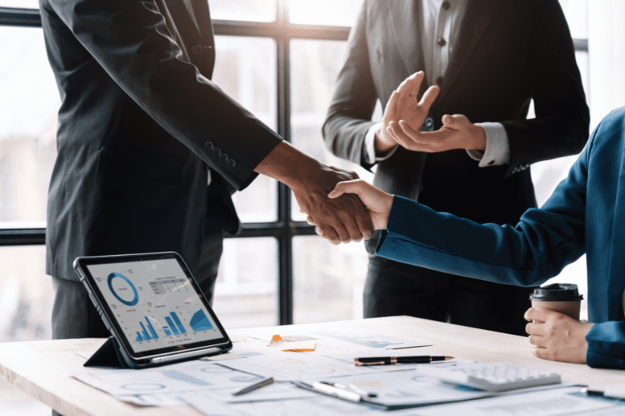 business people shaking hands over mergers and acquisitions deal