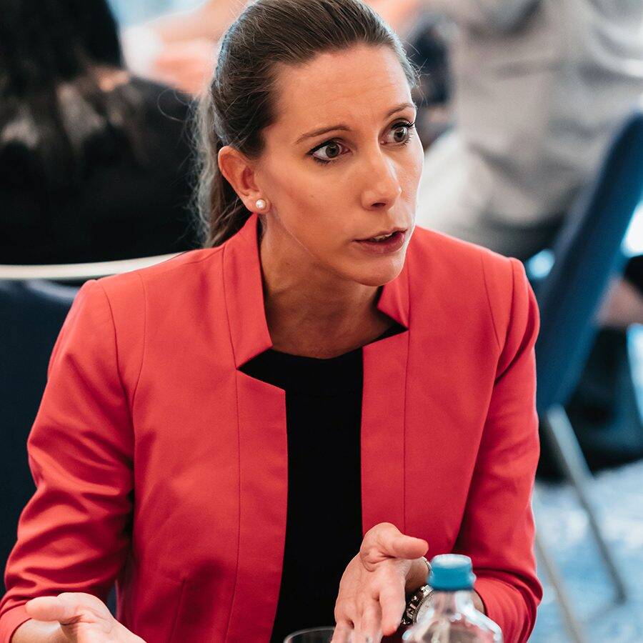 Woman in pink jacket looking serious