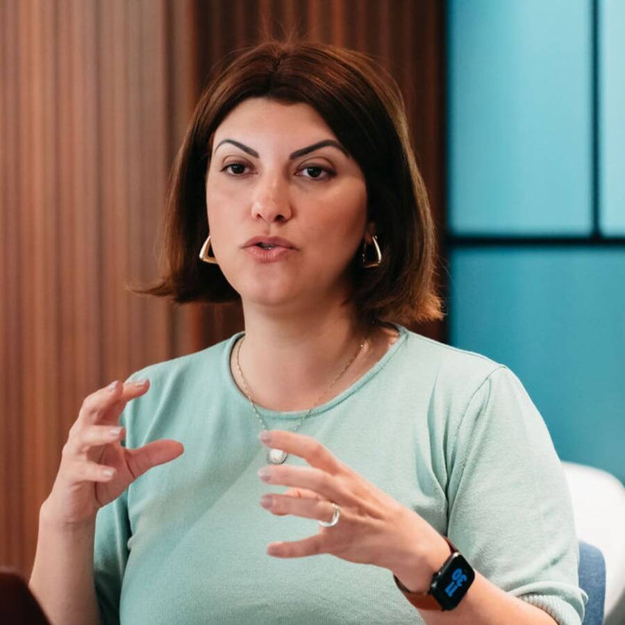 Latina woman in green shirt talking